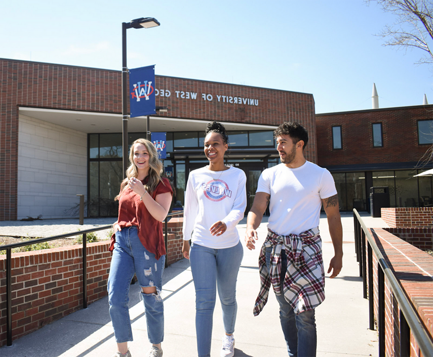 students walking outside of newnan campus building